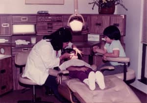 Photo of Dr. Bing practicing in Daly City being helped by an aspiring young Andrew